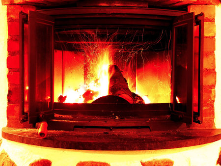 A burning fire in an indoor fireplace
