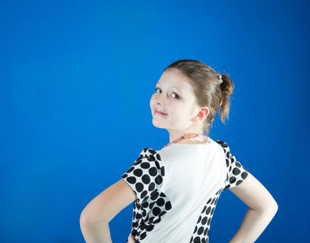 beautiful girl in the blue background coated with face makeupの写真素材