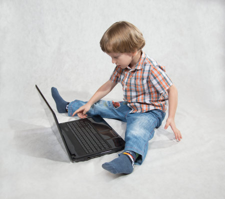 the boy turned on the laptopの写真素材