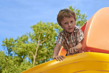 Children have fun in the city garden on a Sunny summer dayの写真素材
