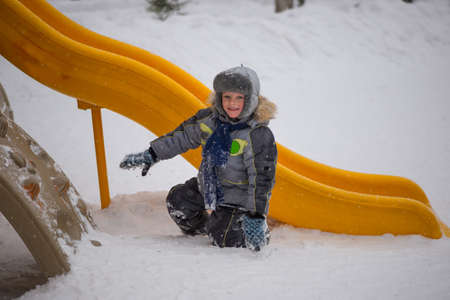 Happy kids enjoying riding on sledge winter ridesの写真素材
