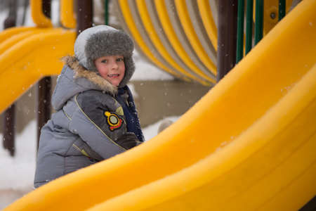 Happy kids enjoying riding on sledge winter ridesの写真素材