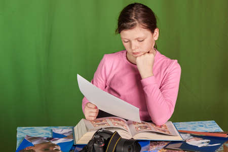 photographer girl selects print ready photos for a magazineの写真素材