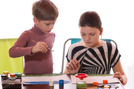 the boy and the girl drawn a water color on a paperの写真素材