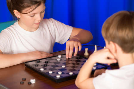 Children play a board game called checkers. Passes blitz.の写真素材
