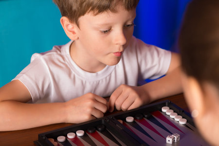 boy playing ancient Eastern game called Backgammon