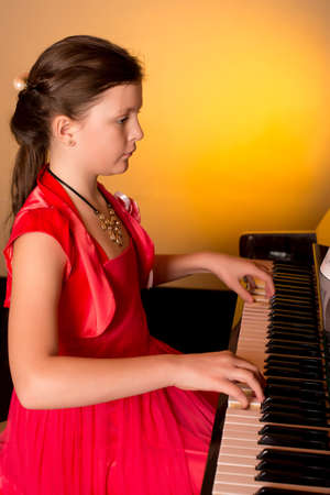 Young Girl Playing Piano. Piano player.の写真素材