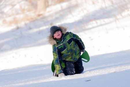 Portrait of a boy on the background of a winter snowy landscape.の写真素材