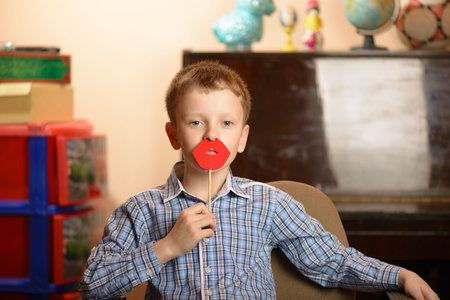 A young man with a mask for a masquerade. Different facial expressions and emotional moods.