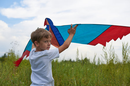 The guy tries to launch a flying kite into the air. Colorful light flying machine.の写真素材