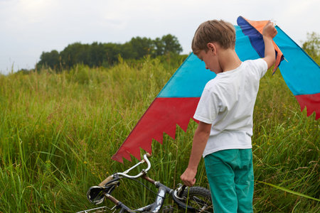 The guy tries to launch a flying kite into the air. Colorful light flying machine.