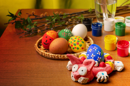 Still life consisting of Easter items. Easter bunny prepared for coloring is lying on the board....
