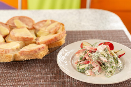 Coffee of fast food. Greens salad in a salad bowl. The vegetables which are grown up without application of GMO. Fruits of tomatoes, crunchy cucumbers, the fresh greens filled with sour cream. Bread and beterbroda without calories.の写真素材