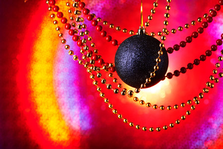 New Year's card. A festive still life on a bright color background. In a ray of light there are a blue sphere and a glass beads.の写真素材