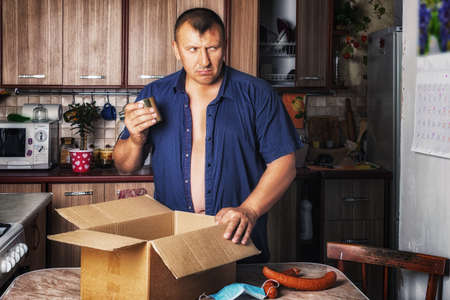 Person hides food from public eyes. A quarantine, epidemic and natural selection, survival in extreme conditions. Low human manifestations. Greed on food.の写真素材