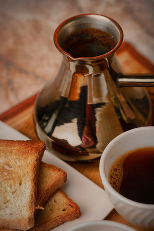 Breakfast for energy. Cup of coffee and toast. Vigor and energy in a sip of caffeine. Morning exercise. Cup of coffee in bed. Ground brewed coffee. Delicious drink.の写真素材
