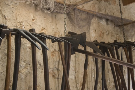 Old wooden mining picks hanging on a wallの写真素材
