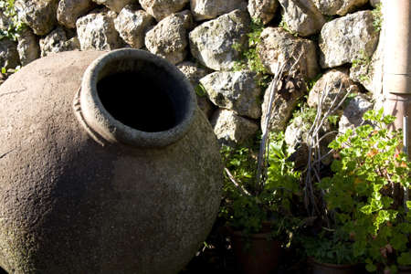Old stone water vessel in gardenの写真素材