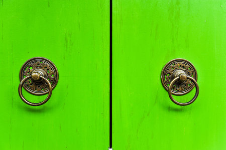 Old thai knocker on the wooden door, Thailandの写真素材
