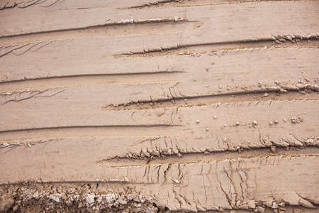Traces of a bulldozer in the sand. The construction site is rammed with machinery.の写真素材