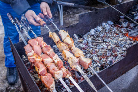 Skewers on skewers are fried over an open fire.の写真素材