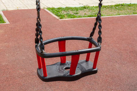 Childrens swing on a playground. Swing on chains.の写真素材
