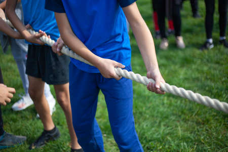 Children pull the rope. Outdoor sports.の写真素材