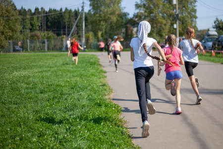 Children compete in running. Jogging in the morning.の写真素材