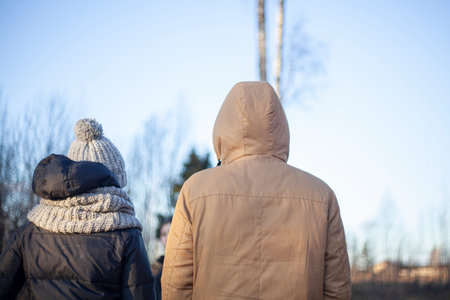 A guy and a girl from the back. Winter jackets.の写真素材