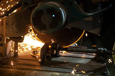 Metal cutting. Grinding steel. Work as a grinder. Sparks from friction. Men's work. Creating a...