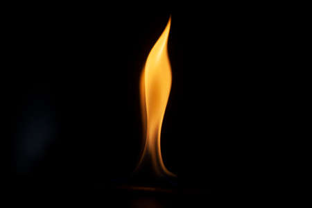 Tongue of fire flame in the dark. Ignition of oxygen in space. Fiery background. Fire of ether in the absence of light. Abstract fire heat background. Single fire. The ignition gel is on.の写真素材