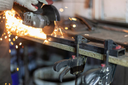 Metal cutting. Grinding steel. Work as a grinder. Sparks from friction. Men's work. Creating a...