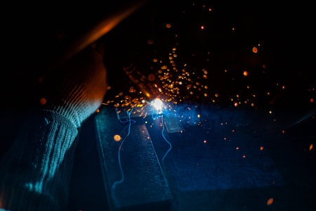 Metal welding. Sparks from electric heating. Work in the workshop. Creation of reliable fastening of...