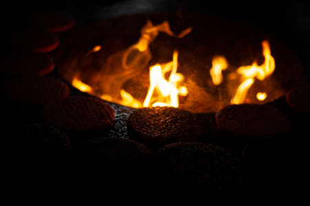 Cutlets are fried over an open fire. Cooking meat on a roasting pan. The meat dish is fried at the stake. Cutlets are molded from minced meat. The art of roasting. Writing rich in animal protein.の写真素材