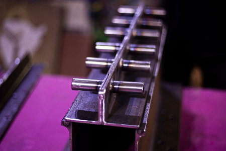 Part of the stairs made of metal. Detail welded from pipes and cut by a grinder. A brushed steel...