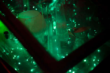 Neon glow of laboratory tools. Cyber punk plot. Box with miracles. Smoke from dry ice inside the box. Transparent box with devices for alchemy. Fantasy production.の写真素材