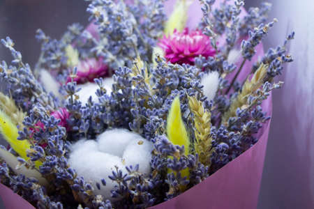 A beautiful bouquet of flowers collected from dry plants. Machine with flowers. A gift for a girl. Inflorescences of all colors. Natural background. Designer bouquet for dates.の写真素材
