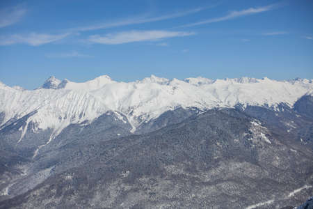 Mountain landscape with snow. Snow-capped peaks of the mountains. High altitude. Background of calm mountains. Sunny weather in the highlands.の写真素材