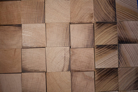 Wooden texture made of cubes. Square polished parts closed in a rectangular row. Background of wood...