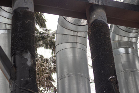 Pipes for hot and cold water. City communications. Heat pipe on the street. Elevated pipes...