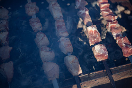 Charcoal food. Barbecue grilled on charcoal. The meat is smoked in mongal. Armenian skewers cooked over an open fire. The national dish of the southern mountain peoples. Lamb is fried on skewers. Appetizing dish.の写真素材