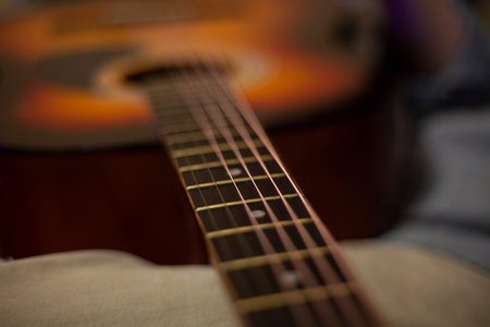 Musical lesson. Tool setup. Acoustic guitar. Installation of strings. Details of the body of the...