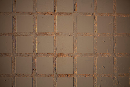 Badly painted tile on the wall. The jets of oil paint have dried on the surface. A square structured...