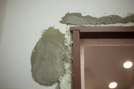 Door repair. Wall decoration. Puttying the surface and foaming cracks when installing the door. Bathroom. Wooden texture on the eaves.の写真素材