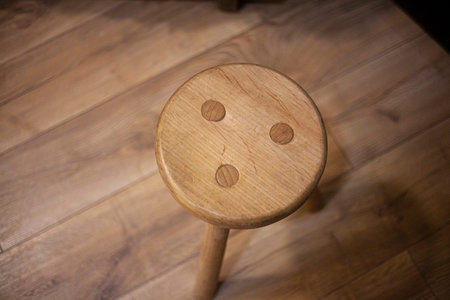 Seat made of wood. Furniture for home. Stool in the old style. Vintage object. Shades of yellow in...