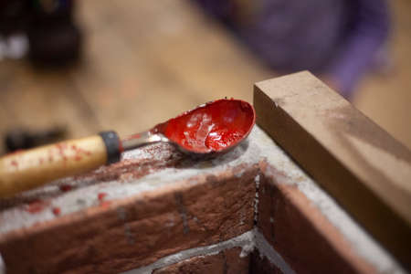 Sealing wax is prepared before use. Special substance for sealing letters. Sealing wax is poured into a spoon and heated. Do it yourself with the old technology a special composition for the design of letters of antiquity.の写真素材
