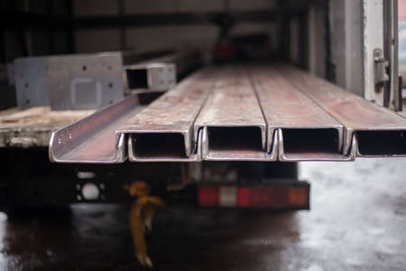 Steel beams in stock. Metal products in the workshop. The metal is prepared for loading. Industrial steelmaking.の写真素材