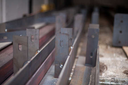 Steel beams in stock. Metal products in the workshop. The metal is prepared for loading. Industrial steelmaking.の写真素材