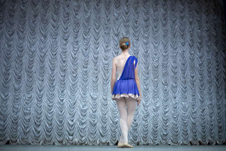 Classical dance of a young girl. Beautiful movements on stage. Flexibility and plasticity of a womanâs body. The correct pirouettes. The dancer shows how to dance.の写真素材