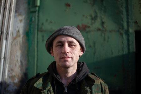 Portrait of a young man. The worker left the garage. Beautiful facial expressions. The image of a...